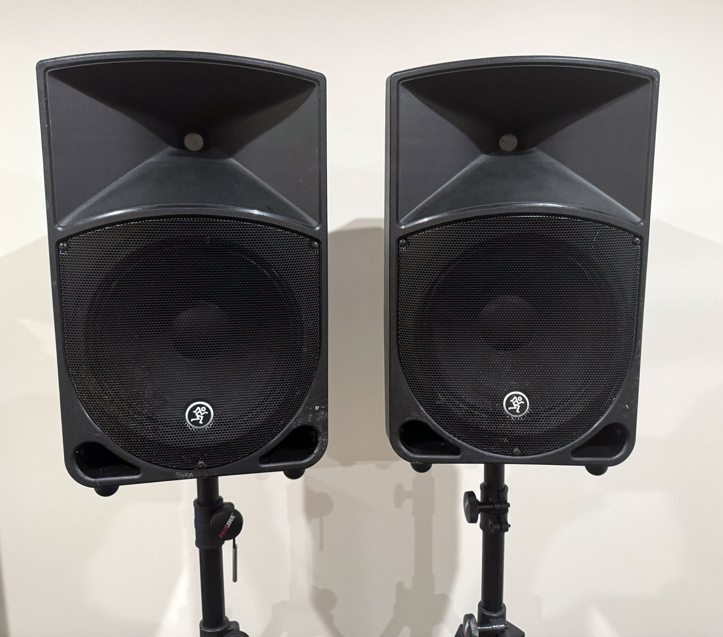 Pair of Mackie Thump12 12" powered PA speakers with two adjustable tripod speaker stands