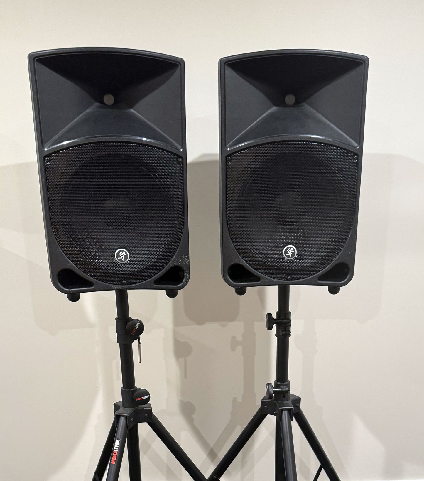 Pair of Mackie Thump12 12" powered PA speakers with two adjustable tripod speaker stands