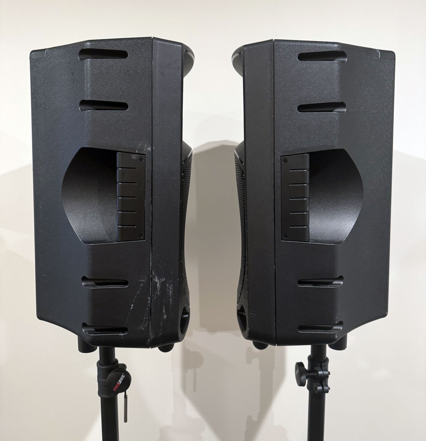 Pair of Mackie Thump12 12" powered PA speakers with two adjustable tripod speaker stands